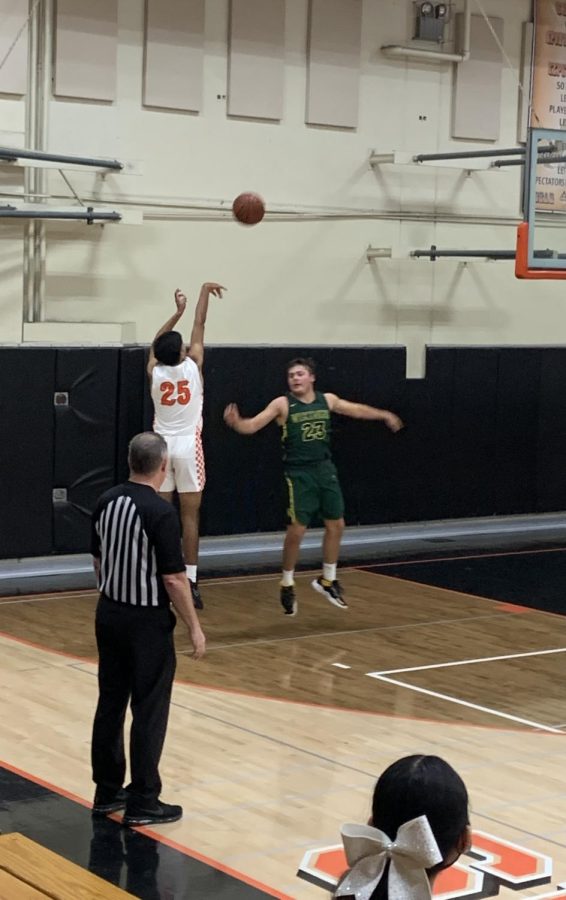 Sophomore Roshan Dail shoots and scores a 3 pointer at a home game in a rivalry game against Kingsburg. 