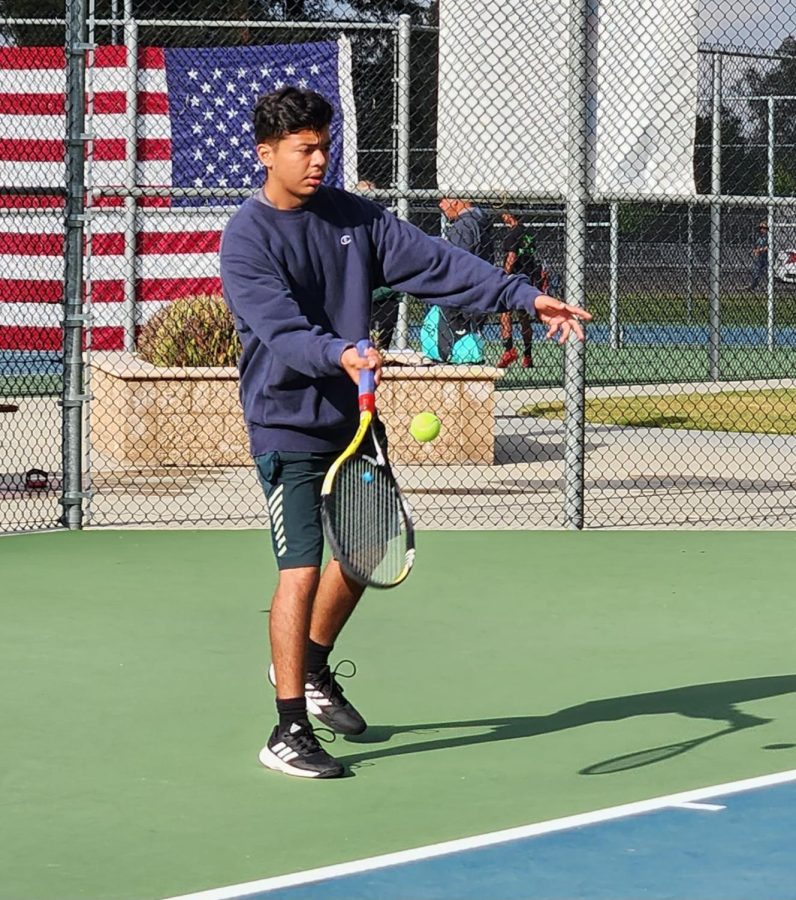 Diego Macias serves the ball.