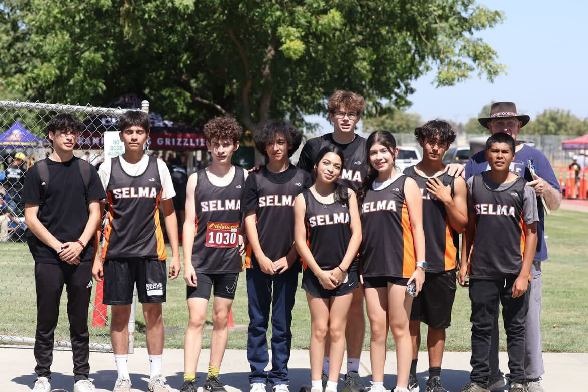 The boy’s and girl’s cross country team huddled together after the season opener at Sierra Pacific.