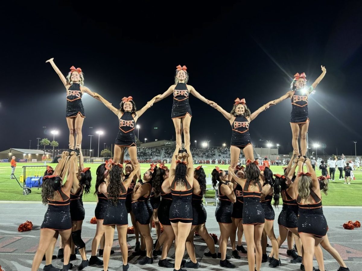 Cheer closes off a performance with a unified stunt (Photograph by Priscilla Fester)