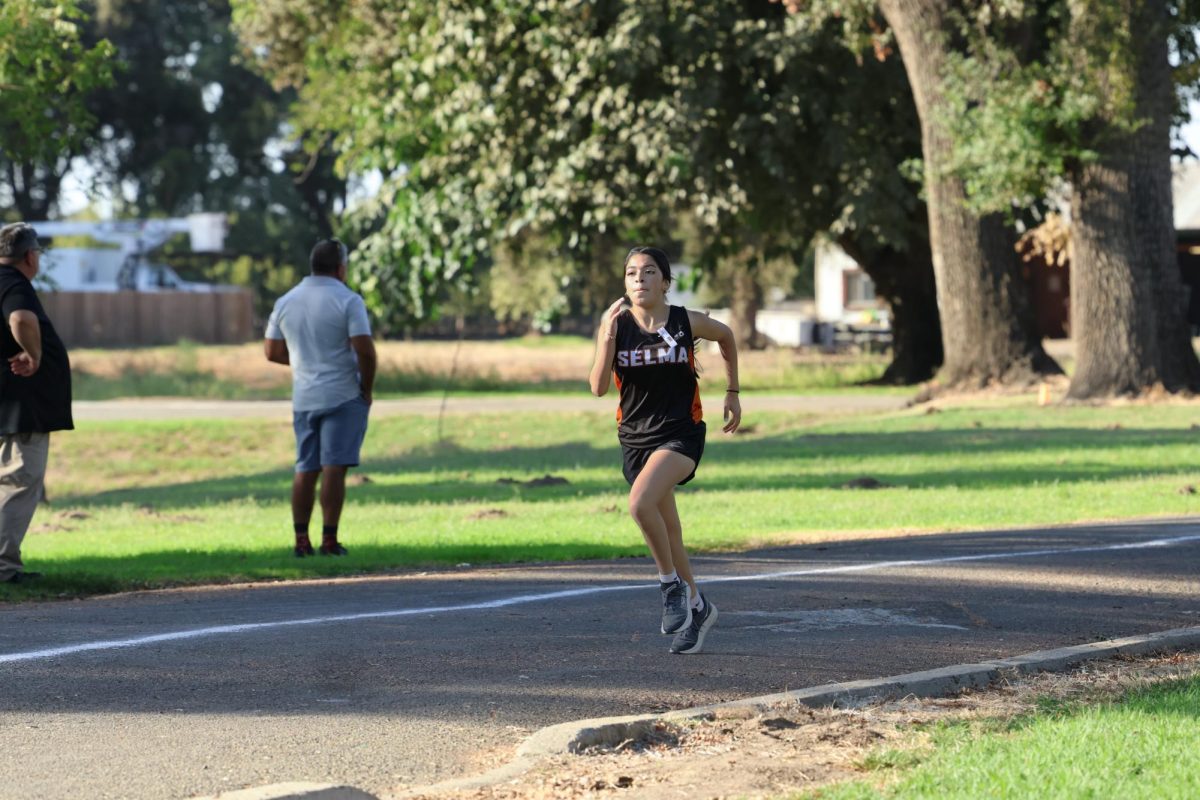 Paola Saavedra Perez racing at Hanford Invitational in Hickey Park.