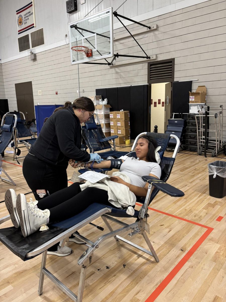 Senior, Elizabeth Zamora braces herself as she donates blood for the Central California Blood Center. 