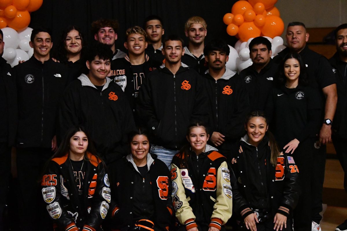 The Selma Highs’ Boys & Girls Wrestling team poses for a photo before their matches on Senior Night. 