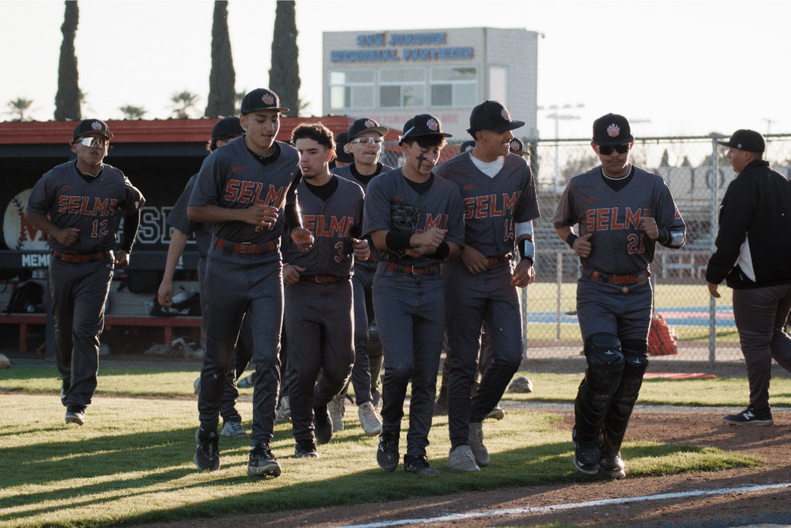 The Selma High Varsity Baseball Team jogs back to their dugout after finishing an inning.