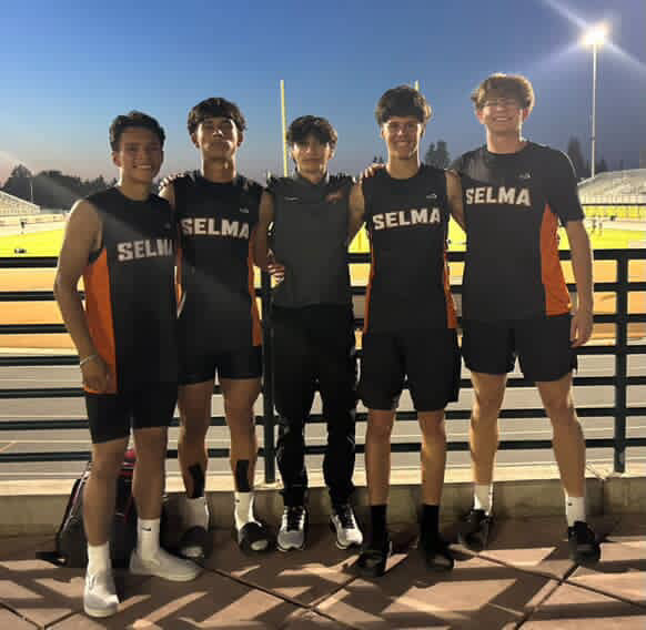 Selma High’s 4x4 Relay Team snaps a photo with long distance coach Coach Gonzales.