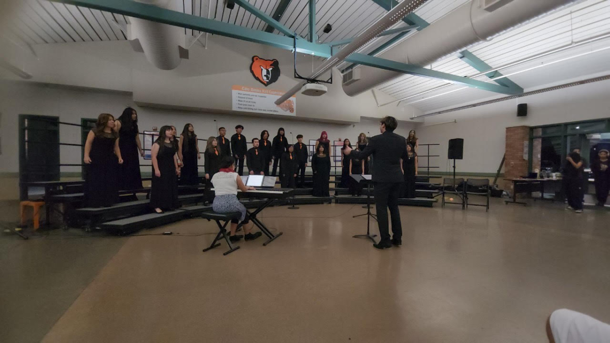 Director Jorge Flores conducts his students while performing their set. 