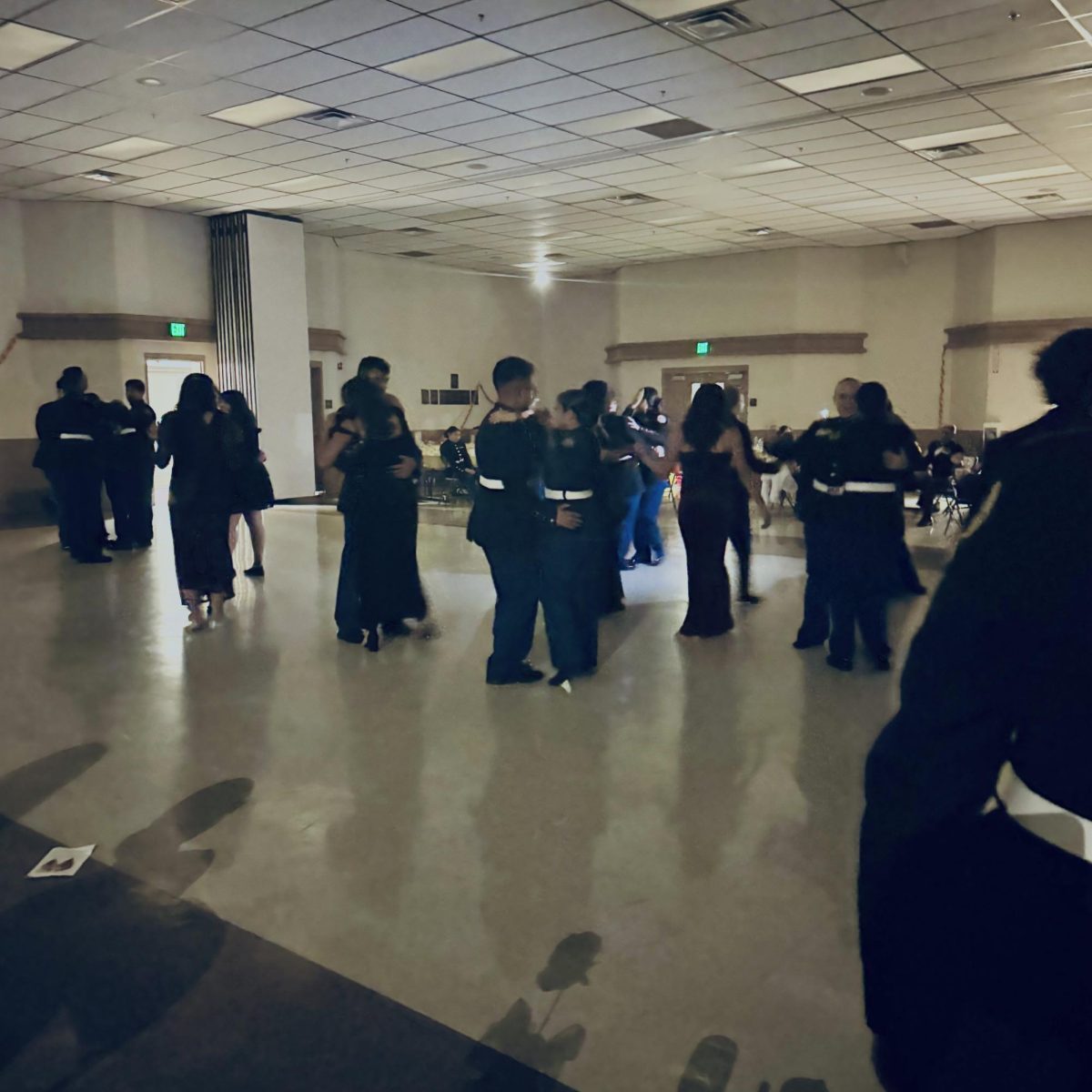 Cadets dancing to slow dance music in the middle of Lopez Hall at 8:30 PM.