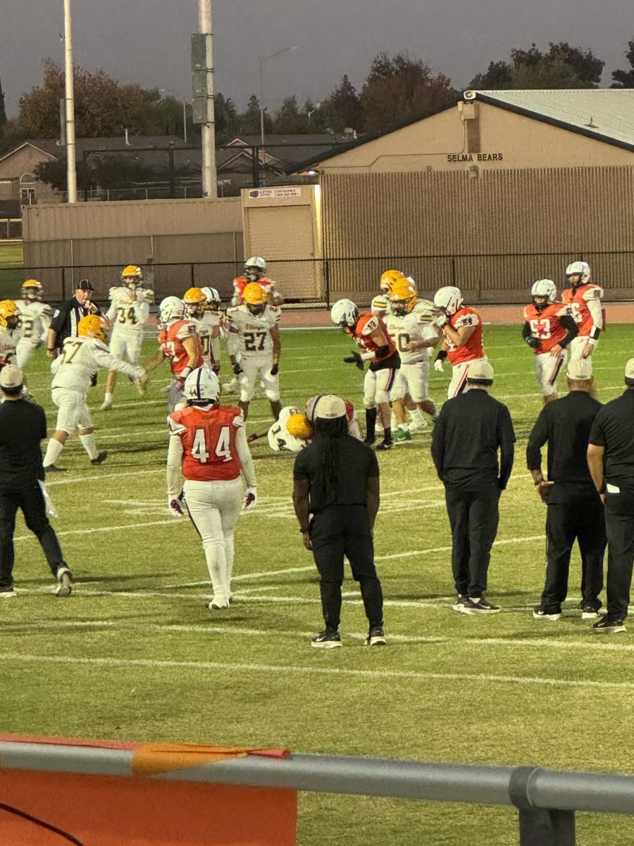 Coach Harshaw observing the intense game.
