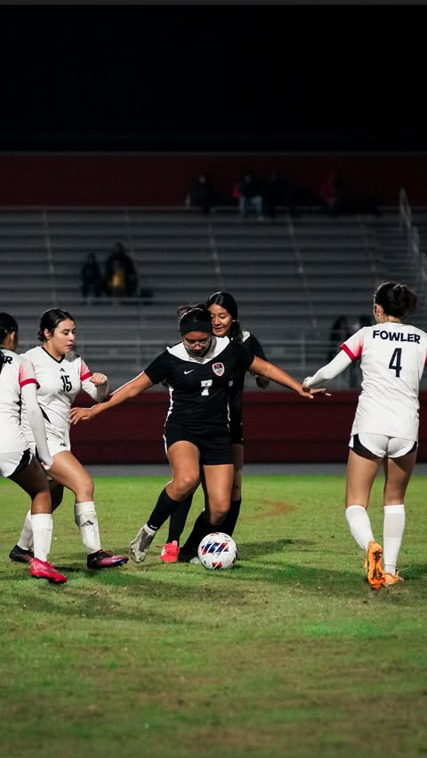 Katie Reyes defends ball from Fowler soccer player.