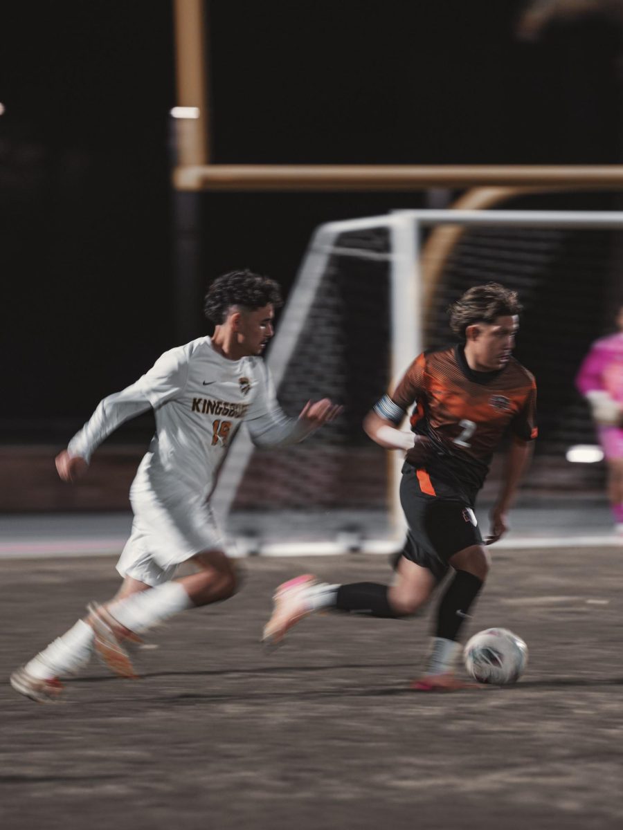 Senior Joel Lopez pushes past Kingsburg.