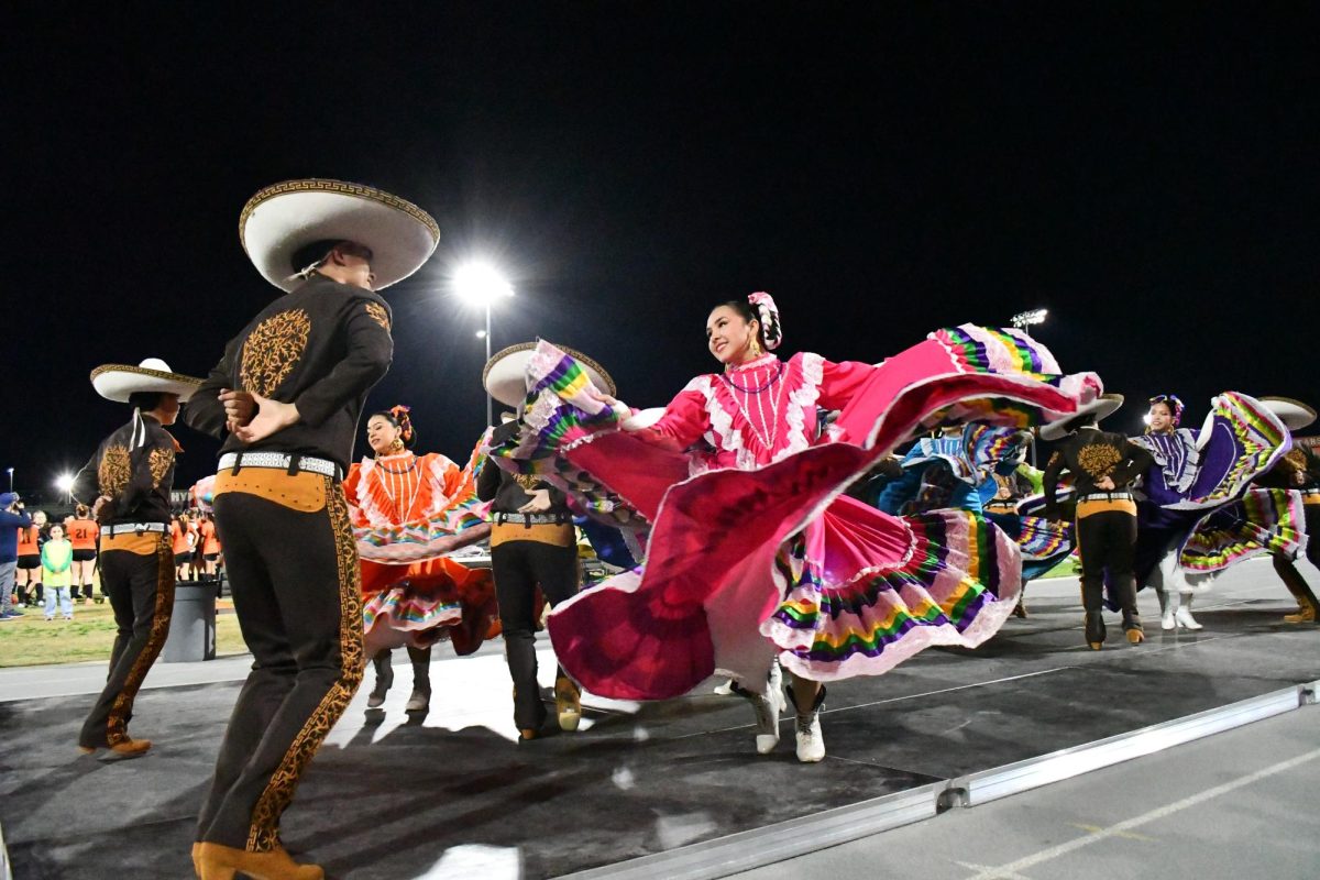 Los Paisanos giving a spirited performance, ringing with joy and a celebration of their roots. 