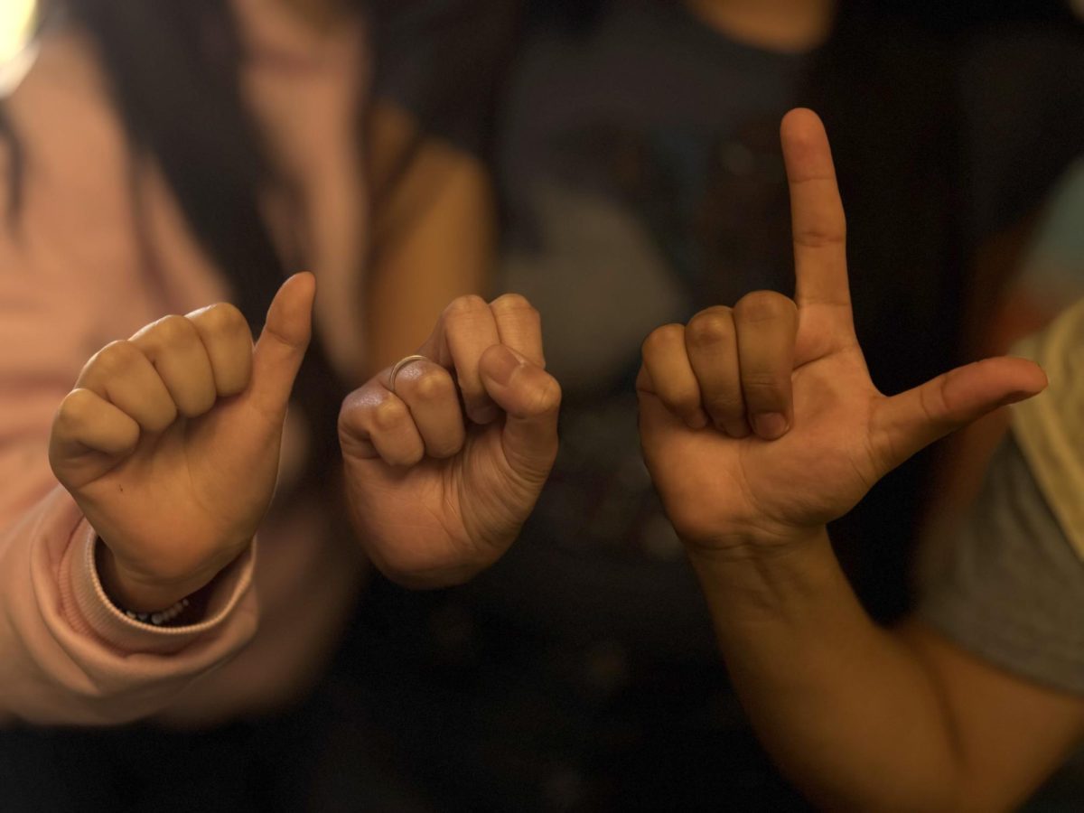 Students spell out ASL using fingerspelling.
